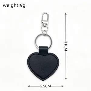 Simple glossy PU leather heart keychain with metal ring and clasp, 11cm length, lightweight.