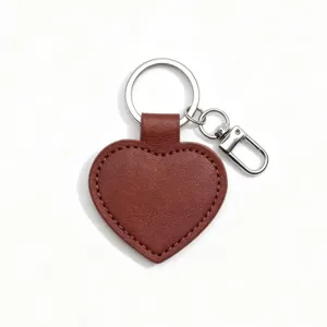 Close-up detail of the brown PU leather heart keychain with metal ring and sturdy clasp.