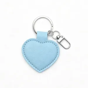 Close up detail of light blue heart PU leather keychain with silver metal ring and clasp.