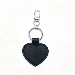 Black PU leather heart keychain with metal keyring and clasp, blank pendant detail shot.