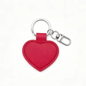 Red heart PU leather keychain detail, smooth texture with silver metal ring and clasp.