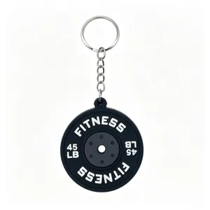 Close-up detail of the mini barbell weight plate keychain pendant, showing textured PVC surface.