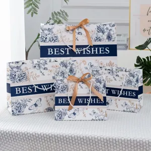 Luxus Papiergeschenktüten mit Henkeln, edlem Blumenmuster und goldenen Schleifen für Geschenke.
