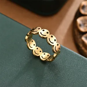 Gold smiley face ring detail shot, stylish linked design jewelry for women and men daily wear.