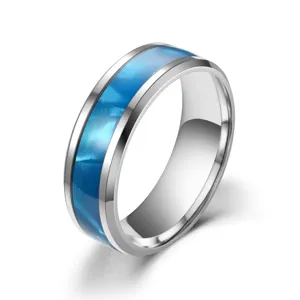 Closeup of stainless steel ring featuring a vibrant blue inlay and polished silver edge.