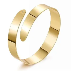 Close-up view of the smooth polished gold finish spiral metal cuff bracelet detailing design.