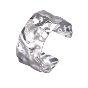 Wide silver metal cuff bracelet with irregular hammered texture for women fashion jewelry.