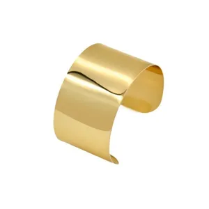 Detailed view of the wide polished gold open cuff bracelet, featuring a sleek modern metal finish.