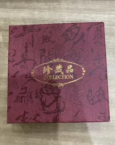 Burgundy jewelry gift box with gold metallic foil collection stamp and vintage calligraphy.