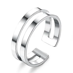 Detail view of a minimalist silver double band open ring, modern geometric metallic jewelry.