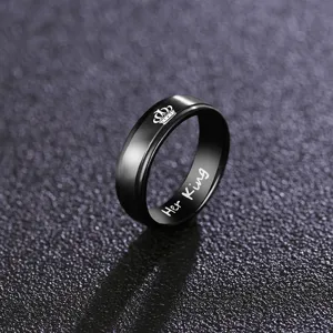 Detail shot of the black titanium steel couple ring featuring a crown and Her King engraving.