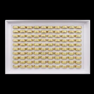 Close-up view of bulk matte gold stainless steel rings, double-beveled 8mm band detail display.