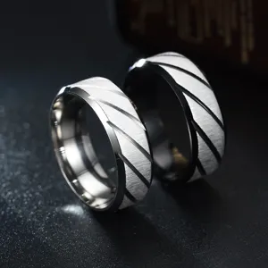 Elegant stainless steel couple rings with stylish diagonal groove cut design for daily wear.