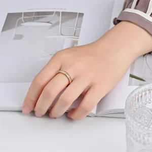 Detail shot of a stylish gold-plated rotating ring with sparkling crystal stones worn gracefully.