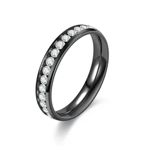Detail shot of black stainless steel ring with channel-set clear rhinestones, close-up view.