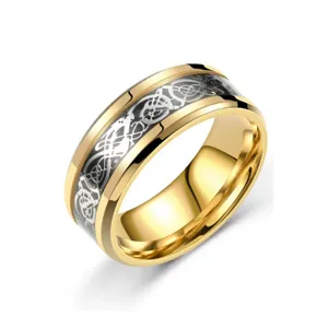 Golden titanium steel ring detail showing intricate silver dragon inlay and polished edge.