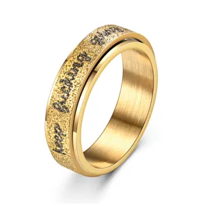Gold stainless steel spinner ring with inspirational text engraving and matte finish detail.