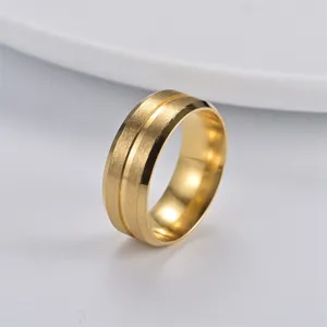 Close-up detail of the 8mm wide brushed gold titanium steel ring with elegant center groove.