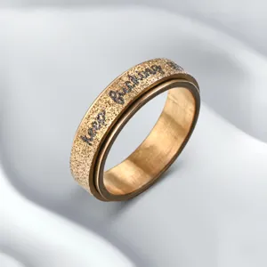 Stainless steel spinner ring for men with pearl sand texture and engraved text.