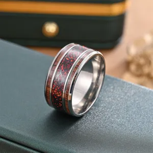 Titanium steel ring with red carbon fiber inlay and black dragon pattern, vintage style.