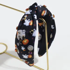 Halloween rhinestone knotted headband detail showcasing ghost print on black fabric.