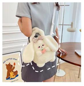 Close-up of a cute white plush bunny crossbody bag with a pink bow and peach detail