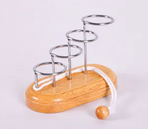 Wooden brain teaser wire puzzle close-up, featuring multi-layer metal rings and wooden base.