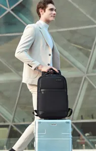 Detailed view of the stylish black commuter backpack in an urban setting, lightweight design.