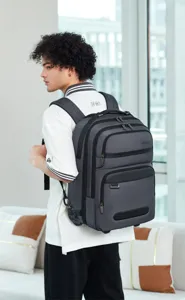 Business travel rolling backpack with wheels and multi-function compartments for men and women.