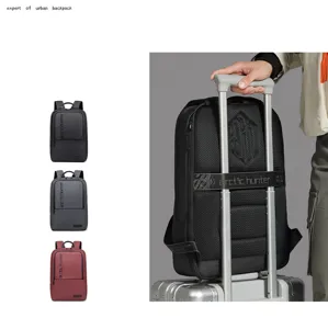 Detail view of urban business backpack attached to luggage handle, showing breathable mesh back.