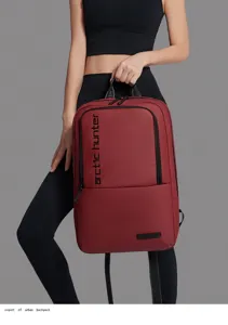 Detail view of the red urban business backpack, showcasing waterproof fabric and branding.