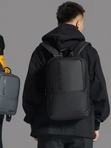 Detailed view of the black business backpack worn by model, showing durable fabric and branding.