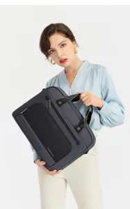 Detail view of business laptop briefcase in dark grey fabric with handle and zipper pockets.