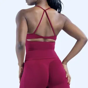 Detail view of burgundy high-waist yoga shorts and cross-back sports bra workout set