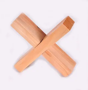 Wooden interlocking puzzle block, traditional brain teaser toy close up detail view.