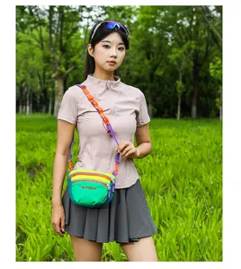 Outdoor colorful crossbody bag detail view, casual shoulder bag worn by model in park.