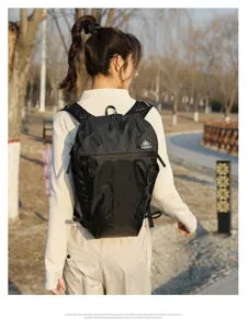 Outdoor backpack detail showing durable checkered fabric, comfortable straps and branding logo.