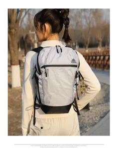 Detail view of the lightweight outdoor hiking backpack worn by a model, showing grid fabric.