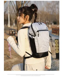 Outdoor hiking backpack detail showing grid pattern fabric, side mesh pockets and durable straps.