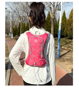 Pink lightweight hydration backpack for running, cycling and outdoor sports. Detail view on model.