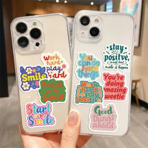 Close-up of motivational quote waterproof graffiti stickers on clear phone cases.