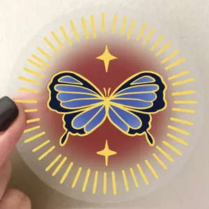 Transparent PET decorative sticker featuring a golden sunburst and blue butterfly design detail.