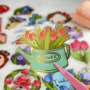 Transparent gold foil journaling sticker featuring a tulip watering can design for DIY decor.