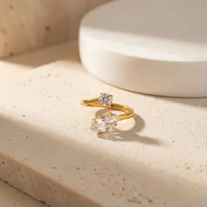 Close up detail view of a chic double stone open ring with sparkling zirconia in a sleek finish.