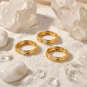 Close-up detail shot of French stacked double-band gold rings featuring sparkling accent stones.