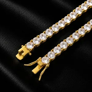 Close-up detail of luxury men gold tennis chain with sparkling cubic zirconia stones.