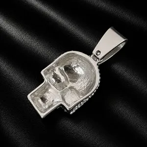 Detailed close-up of a silver skull pendant with sparkling rhinestones for hip-hop necklace.