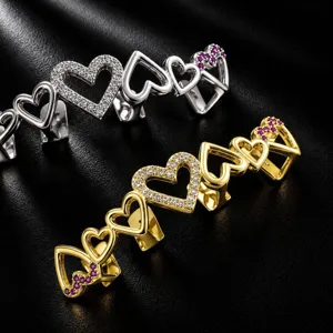 Detailed view of hip hop heart teeth grills sparkling zirconia gold and silver fashion tooth jewelry.