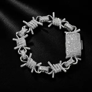 Detailed closeup of a men's hip hop iced out barbed wire chain bracelet with paved cubic zirconia.