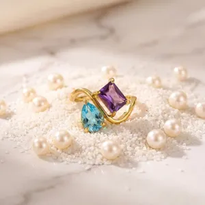 Detailed shot of a luxury gold-plated ring featuring purple and blue gemstones on pearls.
